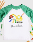 Children's t-shirt with educational graphics and 'pre-school' text, surrounded by school supplies on a white background.