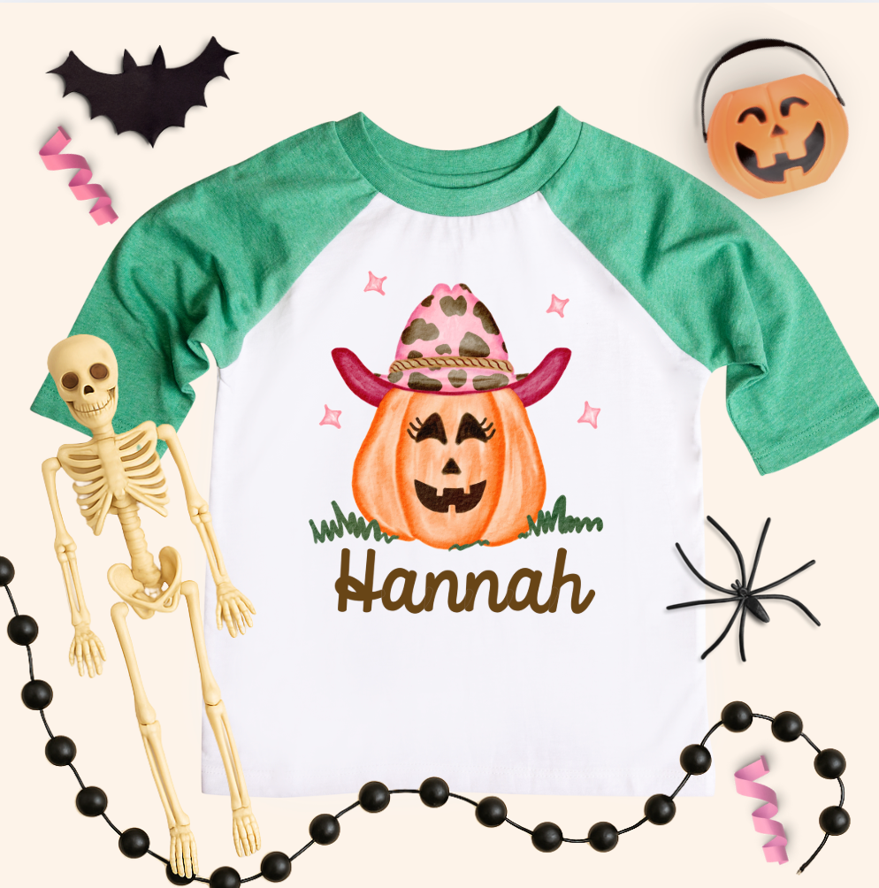 Halloween-themed shirt with a pumpkin and skeleton, surrounded by Halloween decorations.